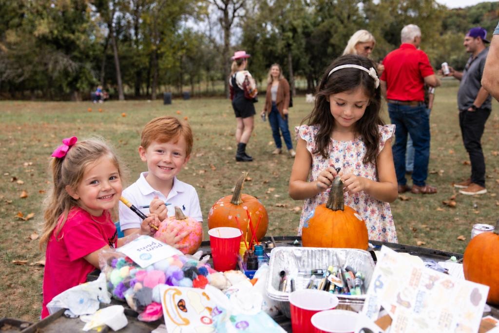Kids decorating pumpkins at Lake Quivira community event